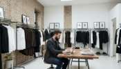 A fashion designer cheking the fit on modle